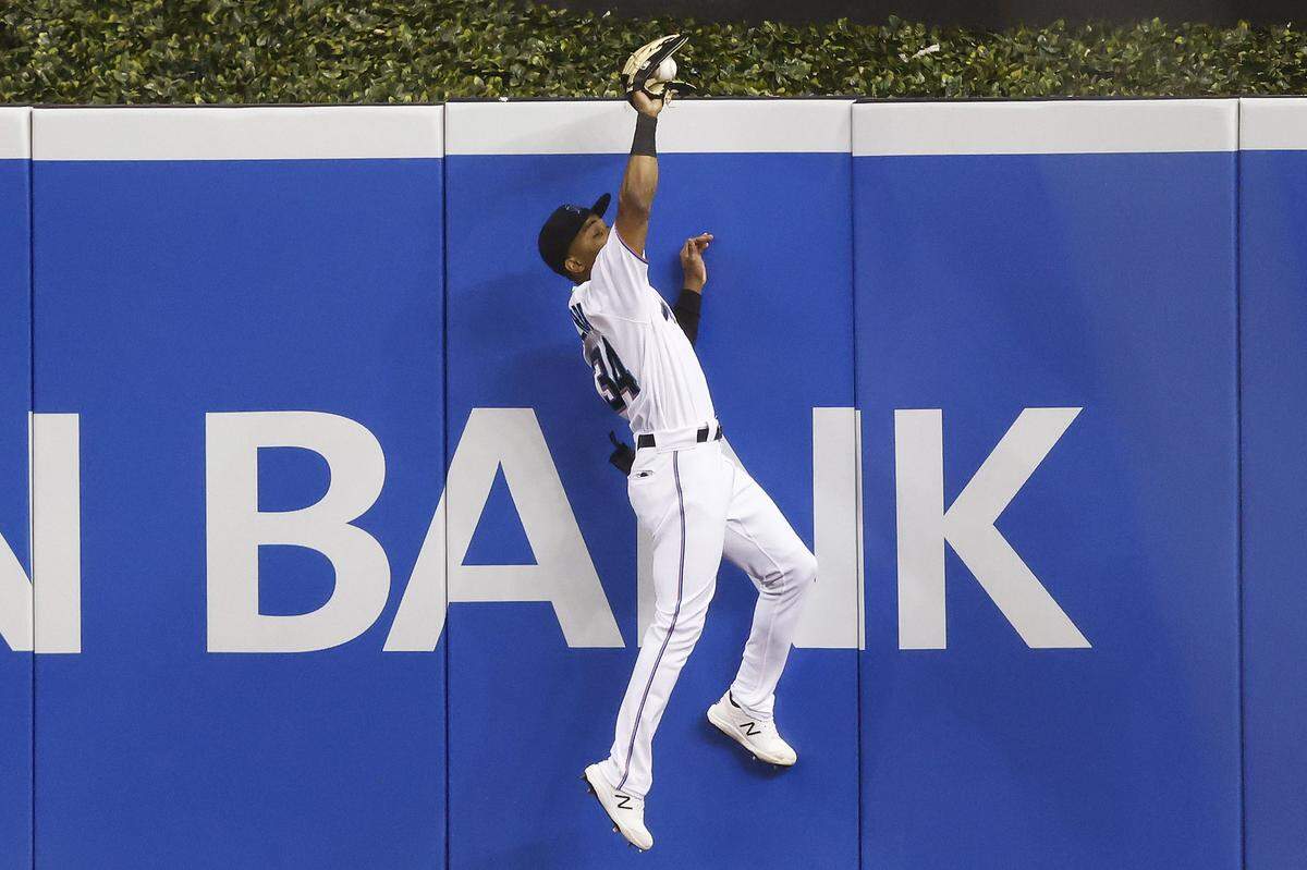 MIAMI, FLORIDA - MAY 06: Magneuris Sierra #34 of the Miami Marlins catches a fly ball hit by Asdrubal Cabrera #14 of the Arizona Diamondbacks during the seventh inning at loanDepot park on May 06, 2021 in Miami, Florida. (Photo by Michael Reaves/Getty Images)
