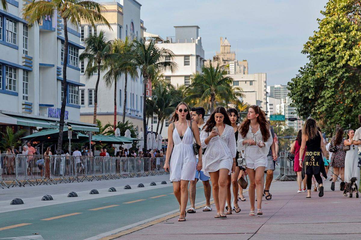 South Beach visitors wallk along Ocean Drive during spring break on Miami Beach, Florida on Saturday, March 9, 2024.