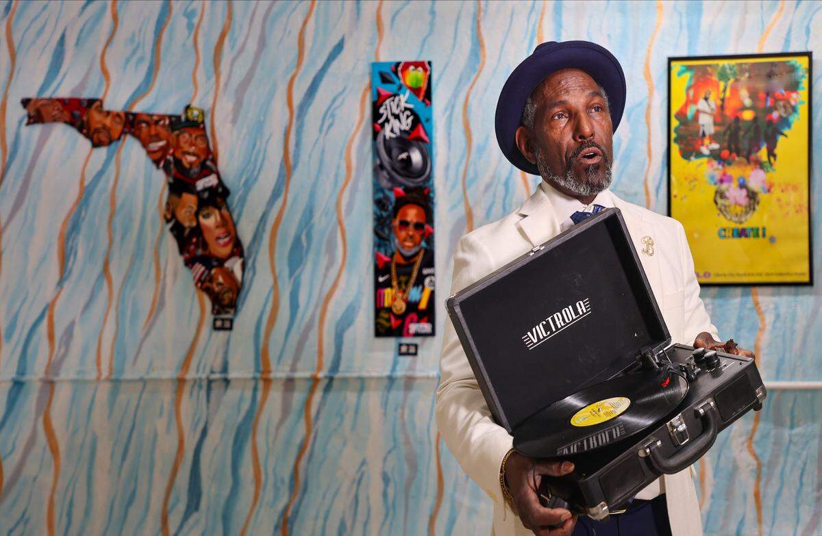 Liberty City native Cuthbert Broadway Harewood, Jr., the designated 2026 grand marshal of the MLK Jr., holds a record player that is part of 305 Hip Hop Museum that he co-owns and co-operates as he retells the origin story of the museum on Thursday, January 8, 2026, in Miami, Florida.  