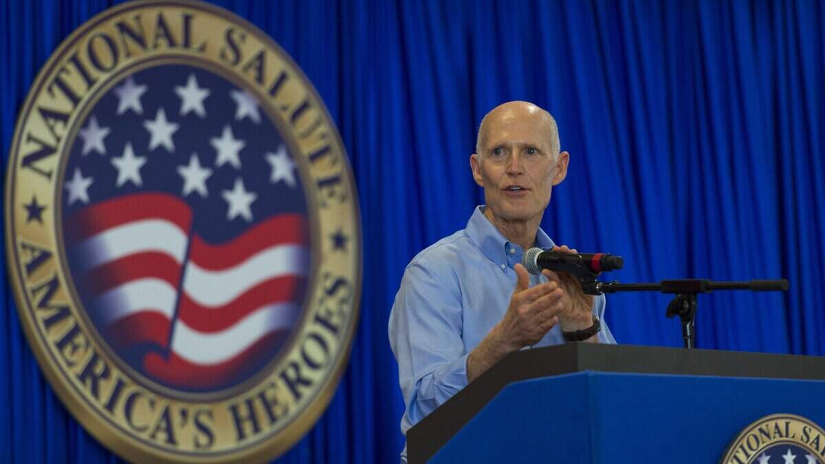 Florida Gov. Rick Scott addresses men and women who will be sworn in to service at the Air and Sea Show during a media event at the Coast Guard Air Station Miami at Opa-locka Executive Airport on Friday, May 25, 2018.  Scott and Florida’s three elected Cabinet members on Friday mounted a new legal defense of the state’s 150-year-old system for restoring the voting rights of convicted felons.