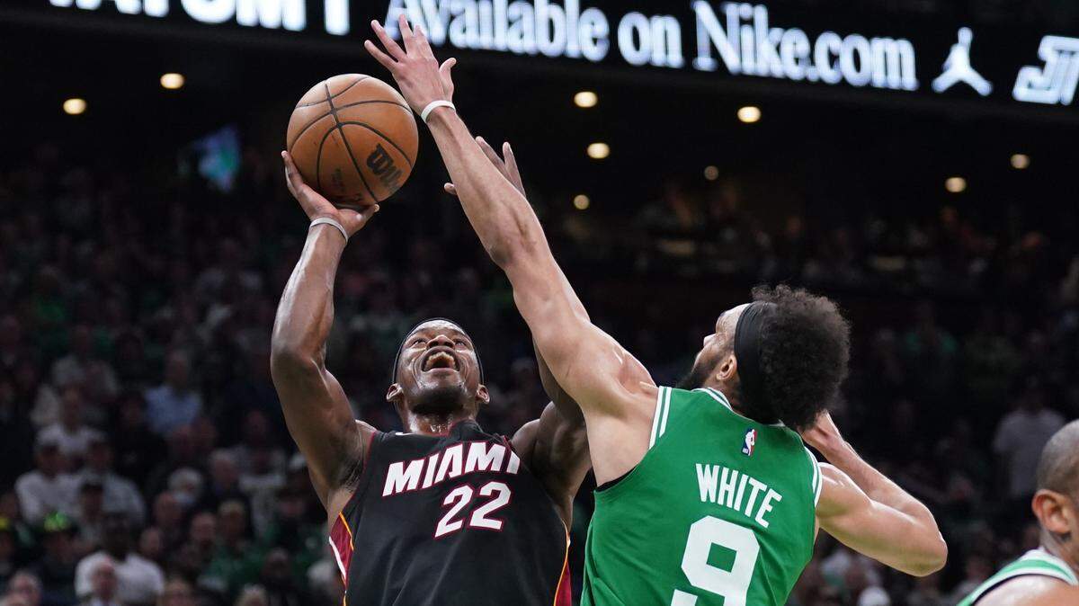 Miami Heat forward Jimmy Butler (22) shoots against Boston Celtics guard Derrick White (9) in the second quarter during game seven of the Eastern Conference Finals for the 2023 NBA playoffs at TD Garden.