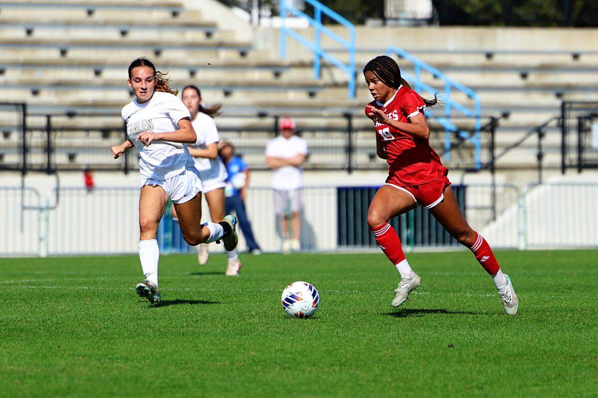 Cardinal Gibbons’ Reagan Hood (left) surges downfield during Thursday’s Class 3A state girls’ soccer semifinal at Lake Myrtle Sports Complex at Auburndale, Fla.
