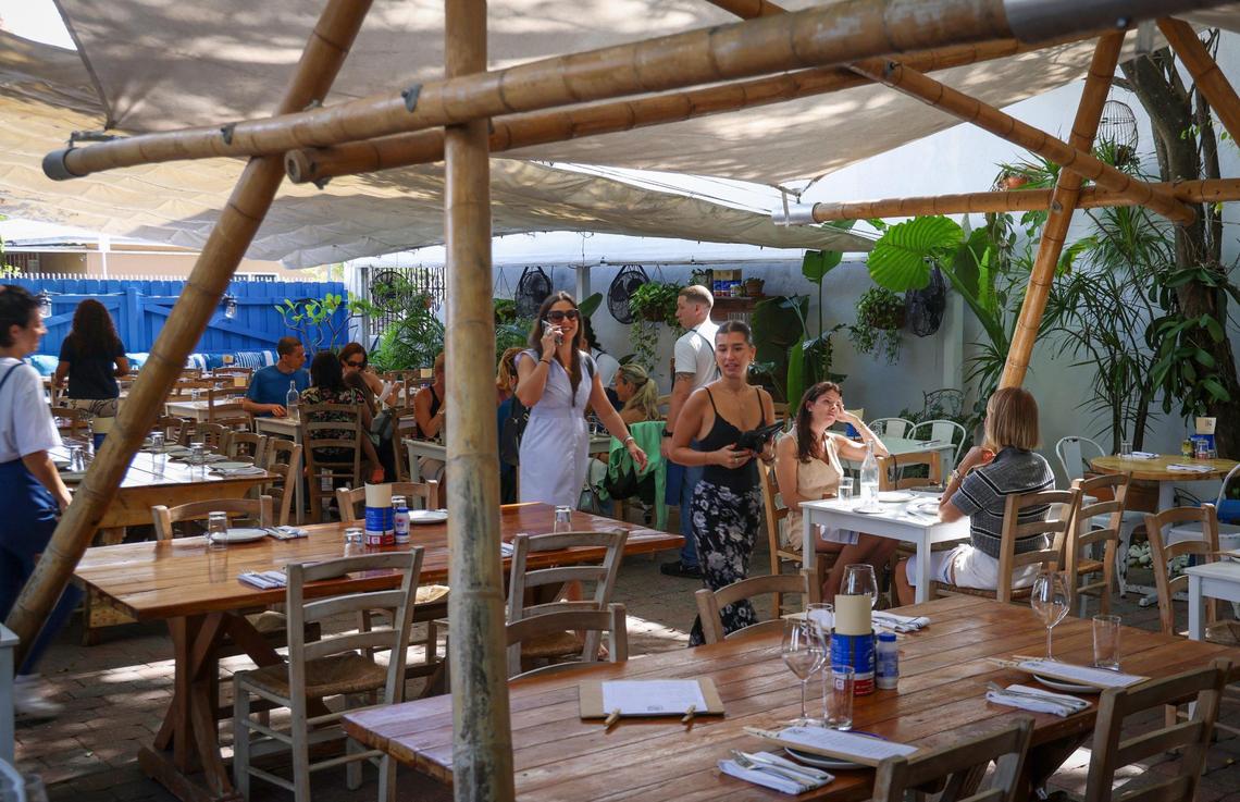 Lunchtime diners are escorted to their courtyard table at Mandolin in Miami’s Design District.
