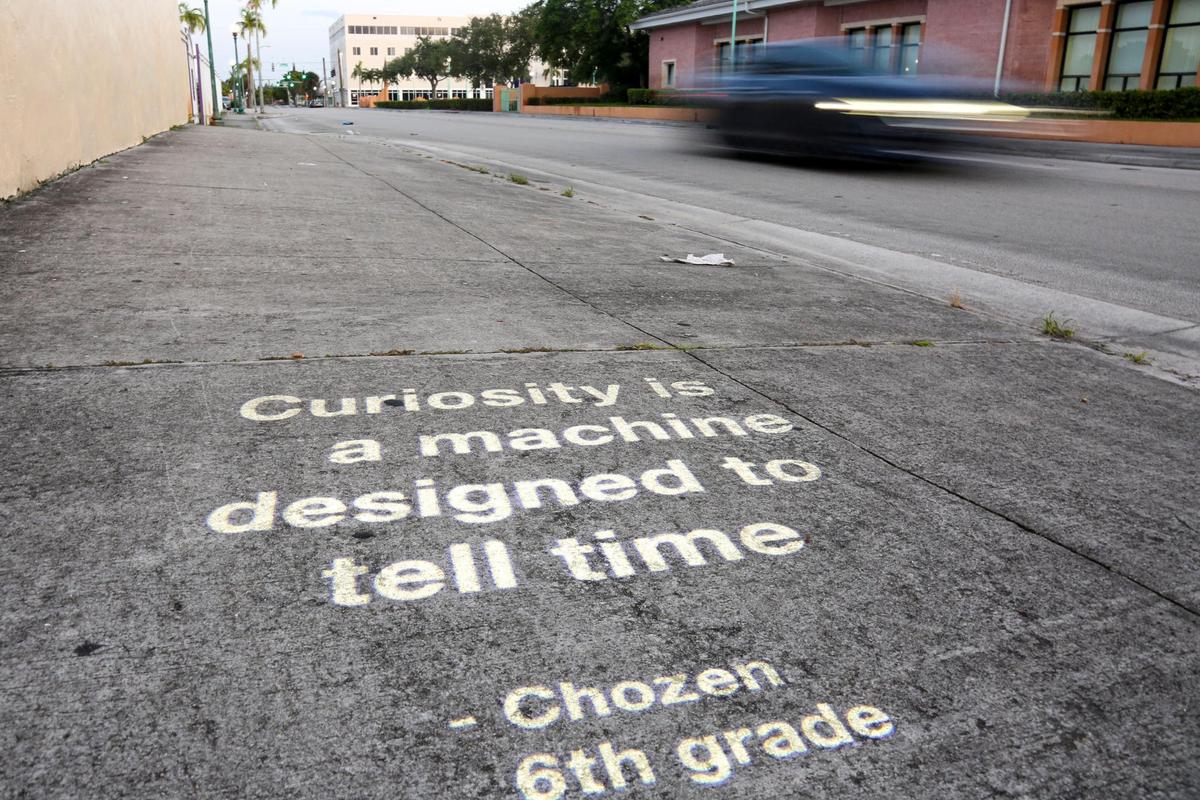 A poem written by sixth-grader Chozen adorns a sidewalk along Opa-locka Boulevard in the city of Opa-Locka, Florida, on Wednesday, July 21, 2021.