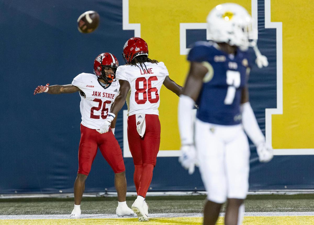 Jacksonville State running back Ron Wiggins (26) celebrates with wide receiver Quinton Lane (86) after scoring a touchdown against the FIU Panthers in the first half of an NCAA DI football game at the FIU Football Stadium on Wednesday, Oct. 25, 2023, in Miami, Fla.