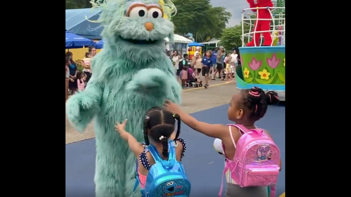 “Sesame Street” character appears to ignore two Black girls during a parade at Sesame Place in Langhorne, Pennsylvania.
