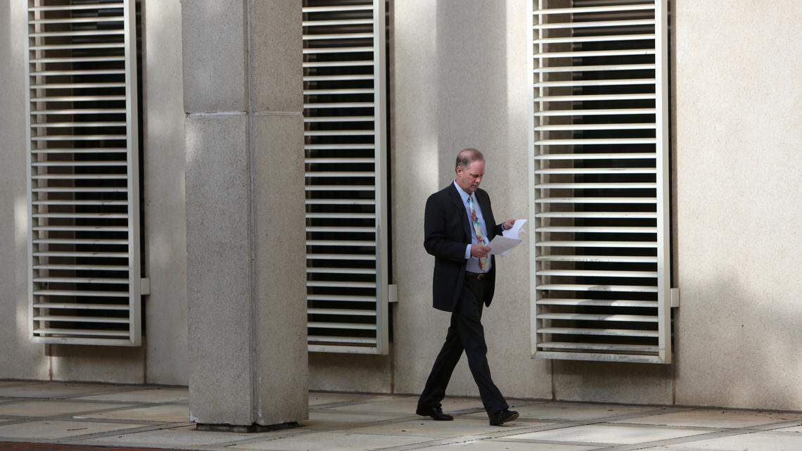 State Sen. Wilton Simpson, R- Trilby, examines papers as he enters the Florida Capitol during the 2019 legislative session.