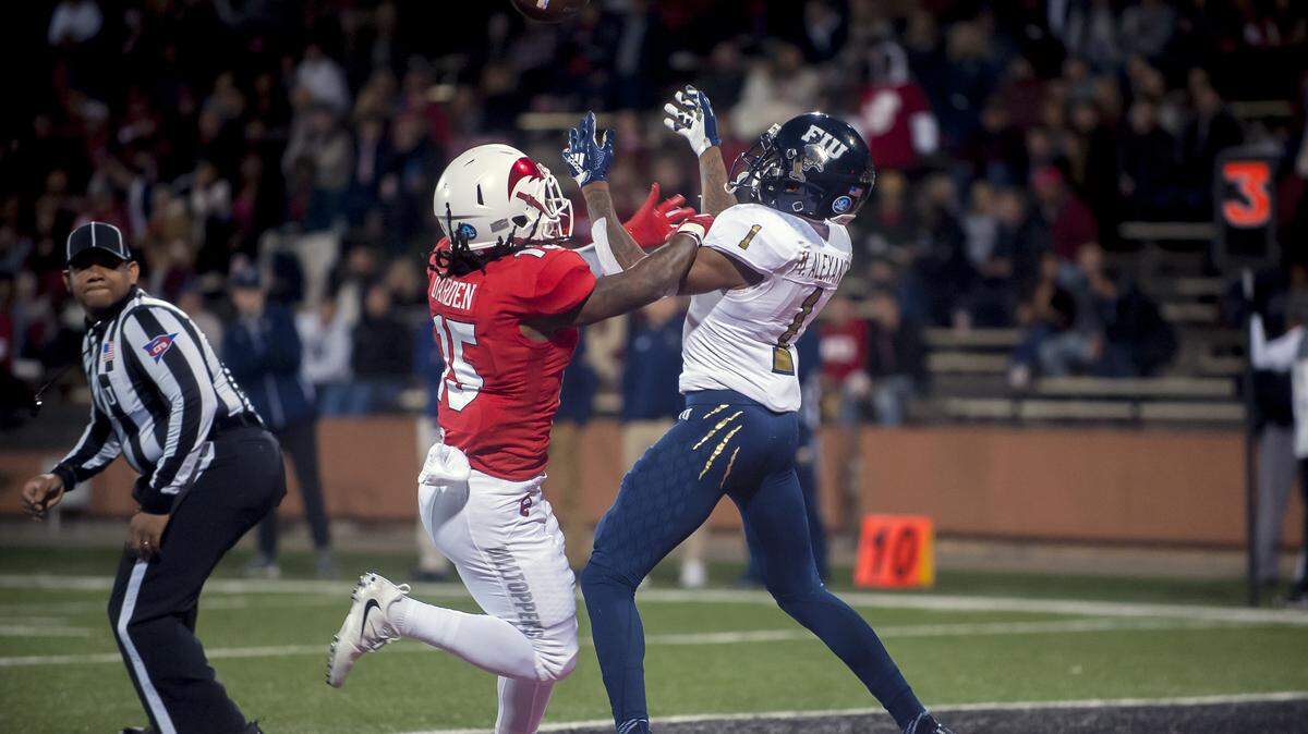 FIU receiver Maurice Alexander (1) catches a touchdown pass Saturday under pressure from Western Kentucky defensive back Ta’Corian Darden (15) during a game at Houchens-Smith Stadium.