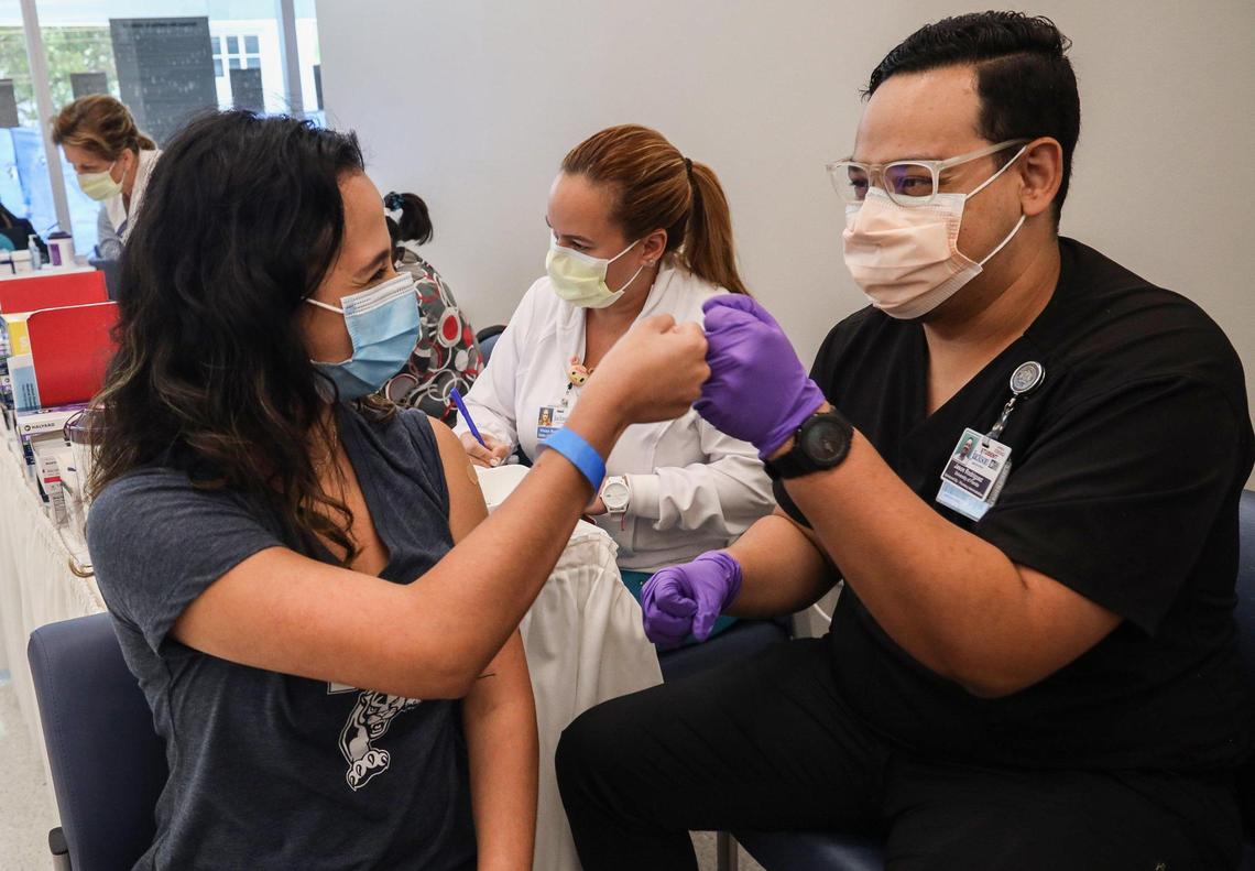 Camila Gutierrez, 21, FIU junior, left, shares a fist-bump with UF pharmacy student Jason Rodriguez, right, after receiving her vaccination at the Christine E. Lynn Rehabilitation Center in Miami, Florida. On Thursday, April15, 2021, Jackson launched a COVID-19 vaccination initiative with colleges and universities in Miami-Dade County, which include Barry University, Florida International University, Florida Memorial University, Miami Dade College and University of Miami. Through this partnership, students who are Florida residents, as well as out-of-state and international students, are allowed to sign up for a COVID vaccine appointment via our online portal.