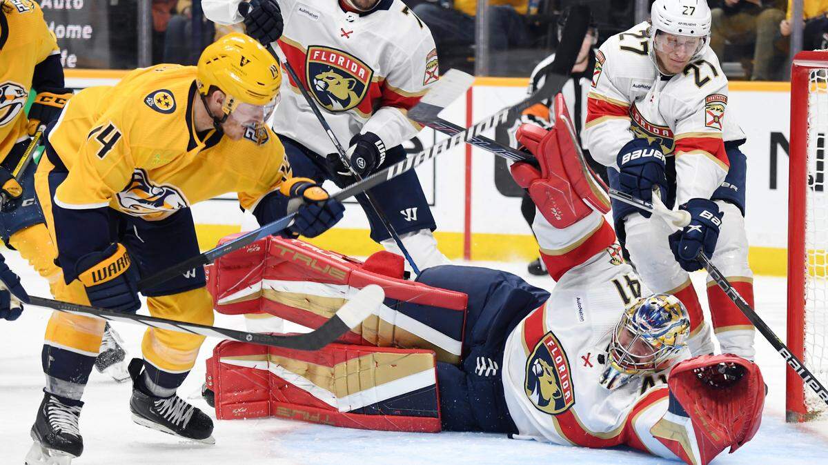 Jan 22, 2024; Nashville, Tennessee, USA; Florida Panthers goaltender Anthony Stolarz (41) makes a save on a shot by Nashville Predators center Gustav Nyquist (14) during the third period at Bridgestone Arena.