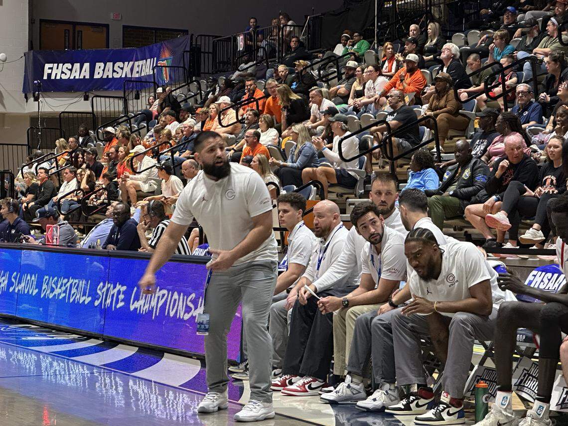Columbus coach Jorge Milo shouts instructions to his players during Saturday’s Class 7A state championship game against Sarasota at UNF Arena in Jacksonville, Fla.