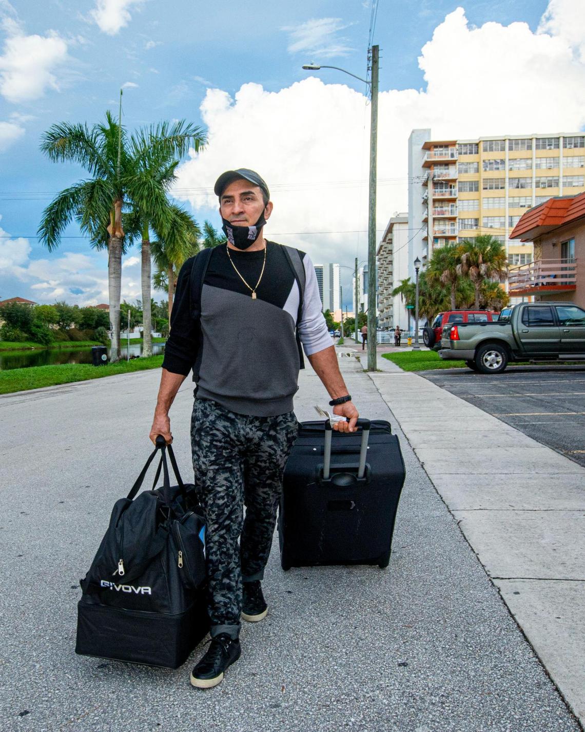 Wilmar Herrera, 40, leaves his apartment with his luggage after the city of North Miami Beach ordered that Crestview Towers Condominium be immediately closed and evacuated Friday evening after a building inspection report found it to have unsafe structural and electrical conditions, city officials announced on July 2, 2021.