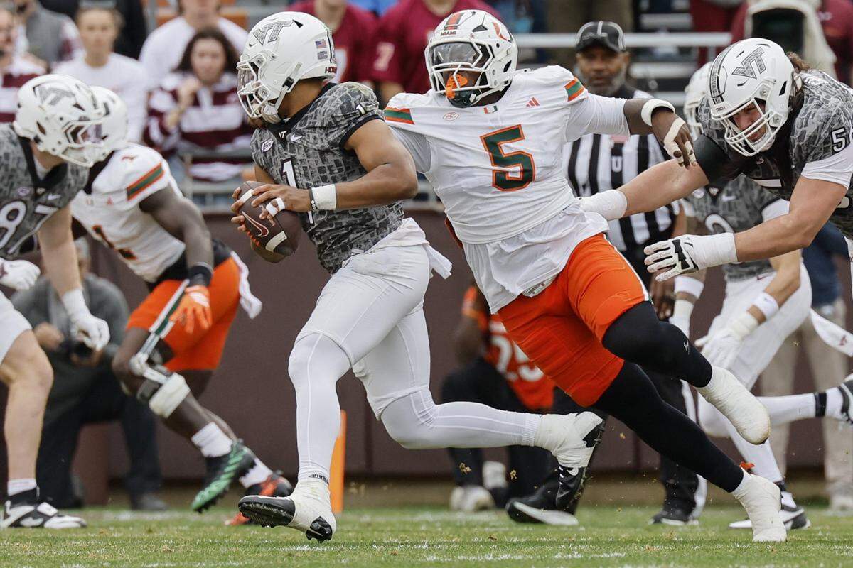 Miami Hurricanes wide receiver Ray Ray Joseph (5) pressures Virginia Tech Hokies quarterback Kyron Drones (1) in the first half at Lane Stadium in Blacksburg, Virginia, on Saturday, November 22, 2025.