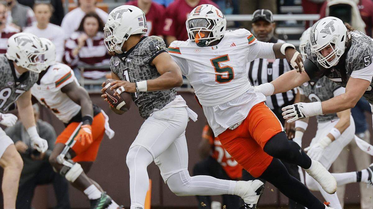 Miami Hurricanes wide receiver Ray Ray Joseph (5) pressures Virginia Tech Hokies quarterback Kyron Drones (1) in the first half at Lane Stadium in Blacksburg, Virginia, on Saturday, November 22, 2025.