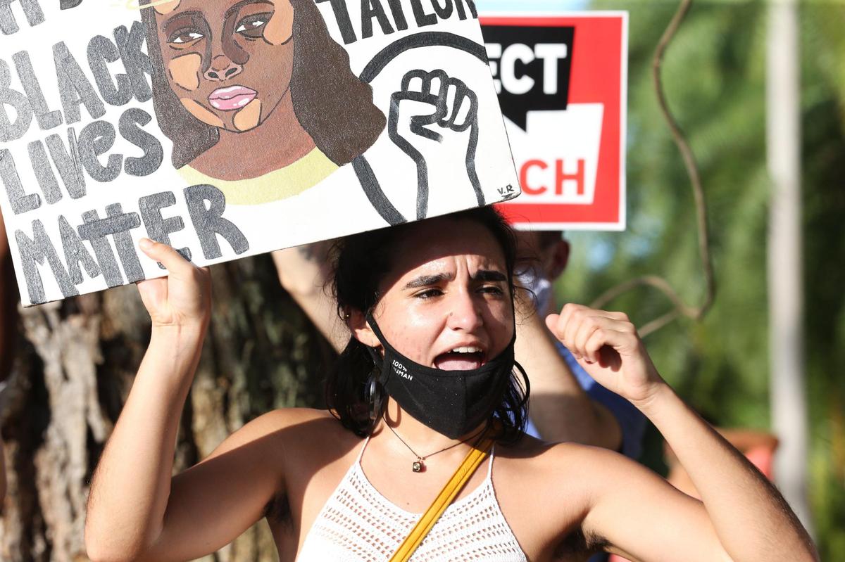 A protester is seen at a rally hosted by Justice for Miami outside the residence of Miami-Dade State Attorney Katherine Fernández Rundle in Coconut Grove demanding her to drop all charges against Black Lives Matter demonstrators, including more than 100 demonstrators who have been arrested in the 70 days since George Floyd’s death, Tuesday, August 11, 2020.