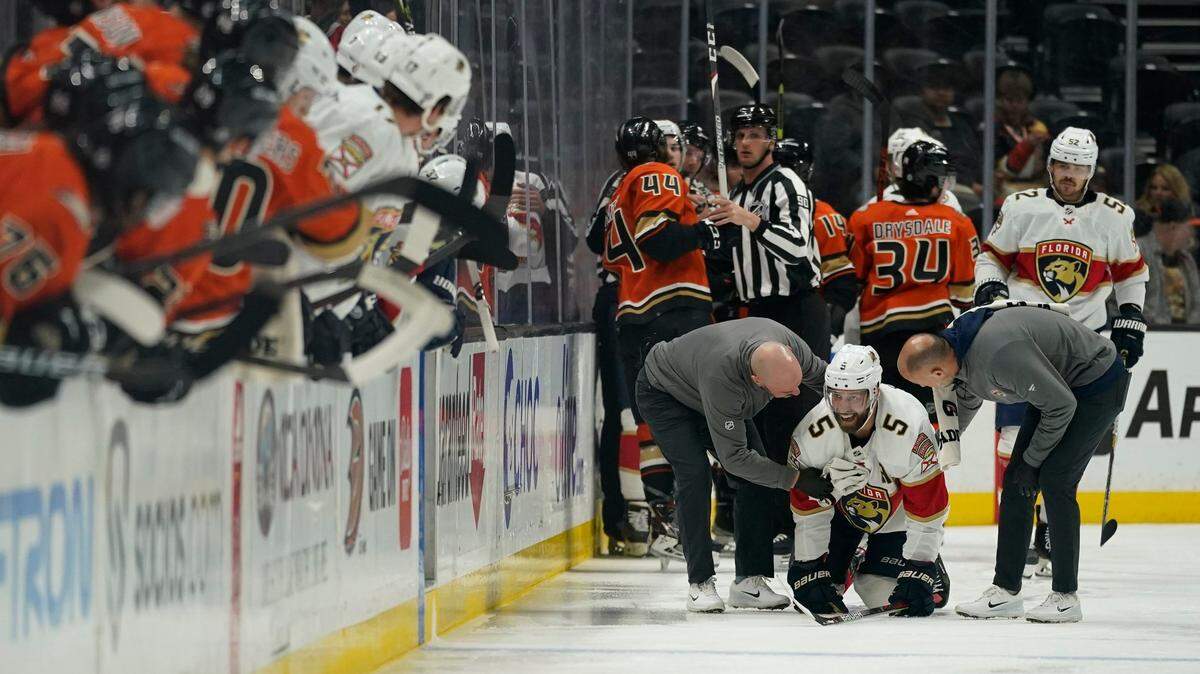 Florida Panthers defenseman Aaron Ekblad (5) is helped off the ice after an injury during the first period of an NHL hockey game against the Anaheim Ducks in Anaheim, Calif., Friday, March 18, 2022. (AP Photo/Ashley Landis)