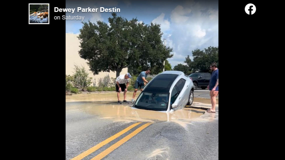 This photo was taken as the driver and a passenger were still waiting to be helped out by passersby. No injuries were reported, officials say.