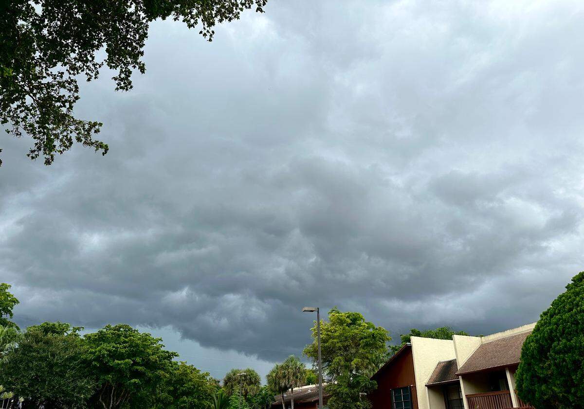 Afternoon storms, fueled by a tropical wave system in the Atlantic, roll into South Florida in this Kendall neighborhood near Florida’s Turnpike on July 27, 2023.