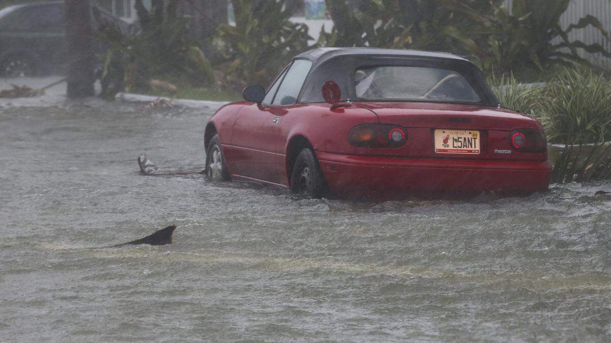 Water rises around a parked car in Miami Beach during Hurricane Irma on Sunday, Sept. 10, 2017.