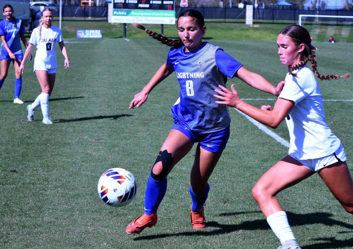 Cypress Bay senior Kelly Brouse handles the ball and the Lake Mary defense while trying to mount a second-half rally in the Class 7A girls soccer state championship game at Lake Myrtle Sports Complex on Friday.