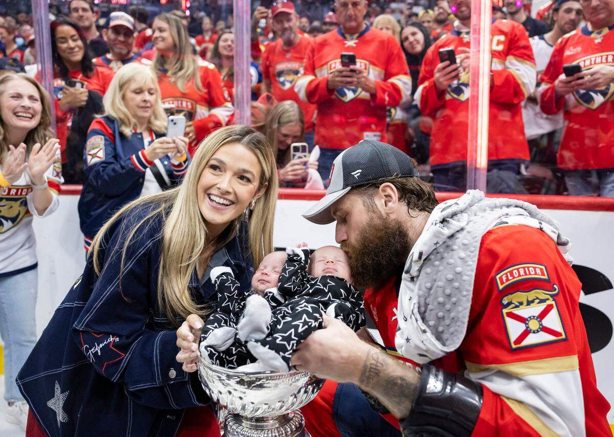 Florida Panthers left wing Jonah Gadjovich (12) with his wife, Allison, place their one-month-old twins, Lion and Adalee, in the Stanley Cup after defeating the Edmonton Oilers in Game 7 of the Stanley Cup Final at Amerant Bank Arena on Monday, June 24, 2024, in Sunrise, Fla.