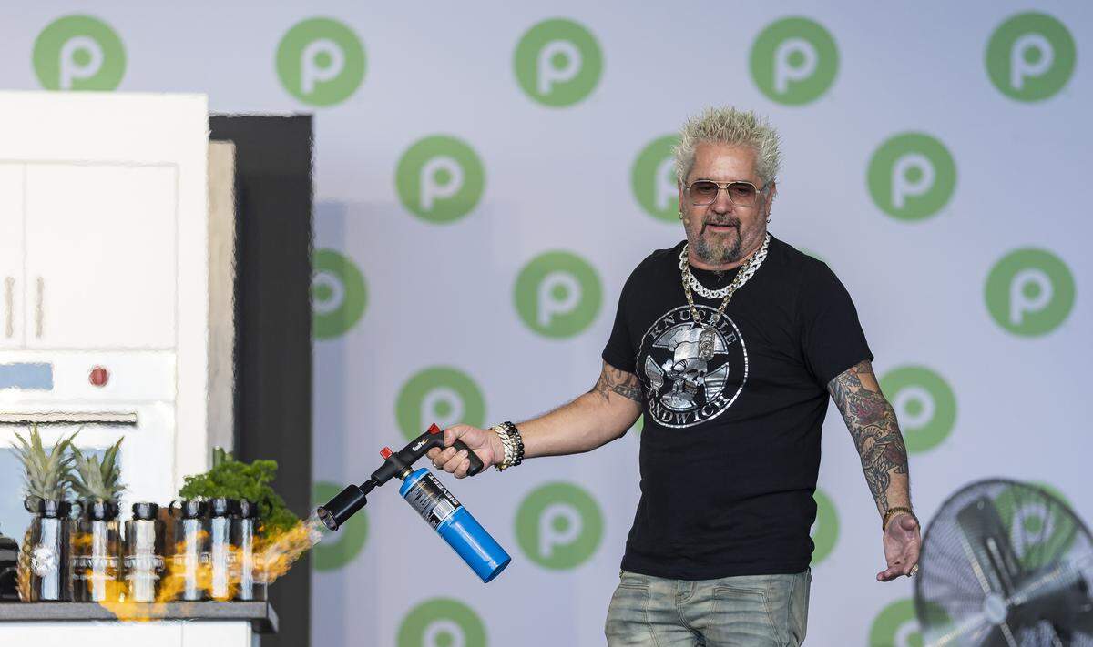 American celebrity chef Guy Fieri uses a torch as he prepares a drink for guests attending the Goya Foods' Grand Tasting Village during the Food Network South Beach Wine & Food Festival on Saturday, Feb. 21, 2026, in Miami Beach, Fla.