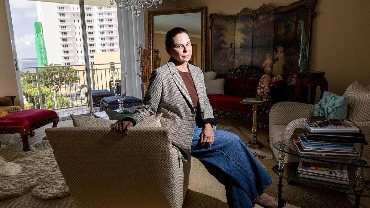 Cynthia Muniz is photographed in her condo on Brickell Key on Friday, July 18, 2025, in Miami. High special assessments and rising association fees have forced Muniz to lower the asking price of her condo by about 25%.