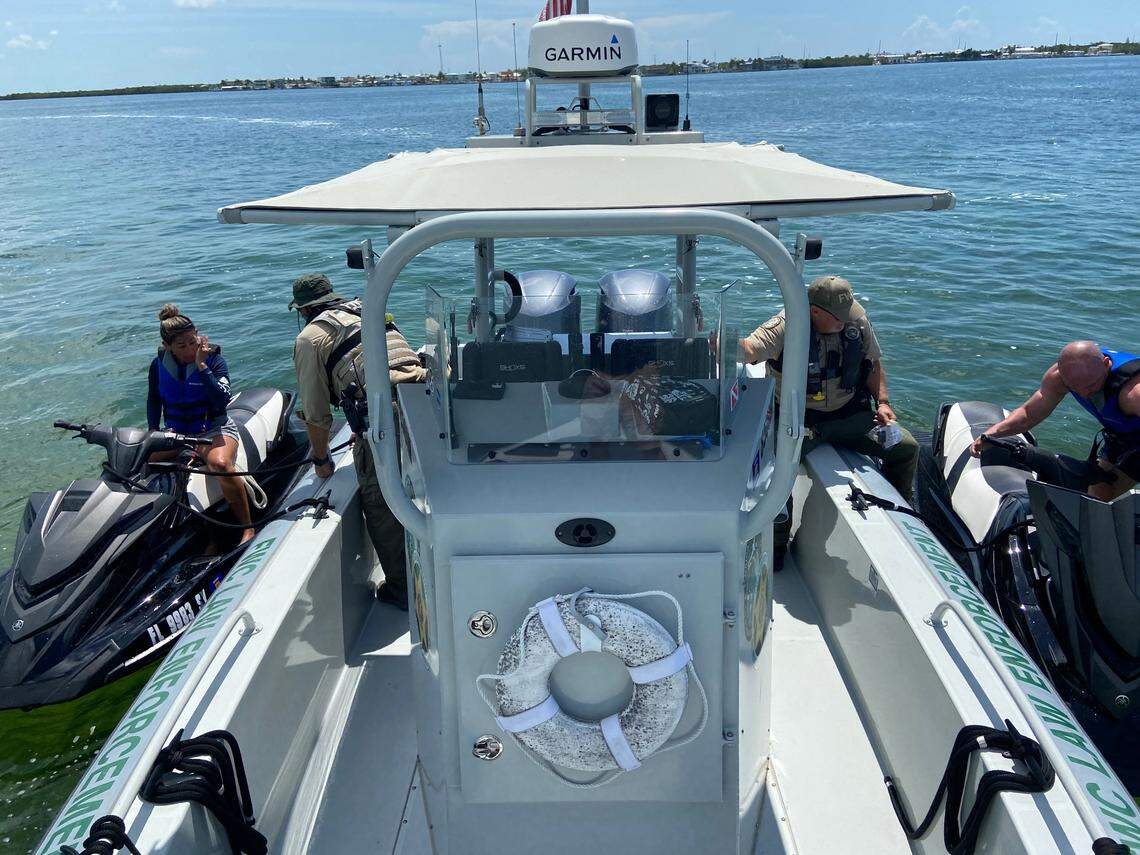 Florida Fish and Wildlife Conservation Commission Officers Jason Rafter and Bobby Dube conduct a safety check with two people riding personal watercraft on Florida Bay in Islamorada Sunday, May 30, 2021.