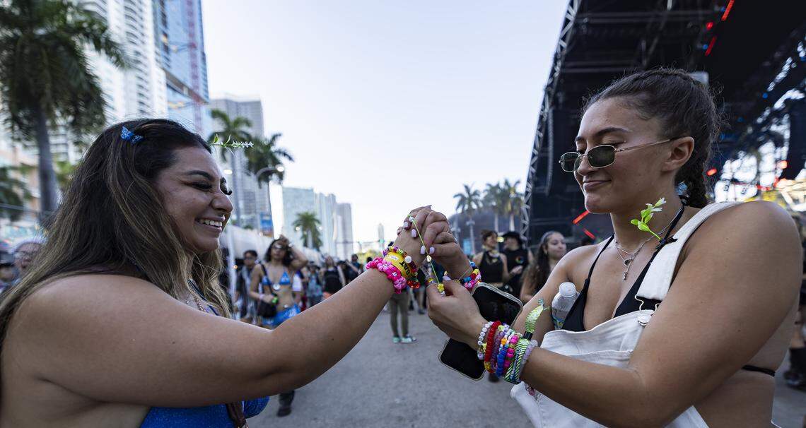 Shivani Tailor, left, from Orange County, California, and Ariel, from Miami, give each other kandi bracelets as they attend Ultra Music Festival’s 26th anniversary at Bayfront Park on Saturday, March 28, 2026, in downtown Miami, Fla.