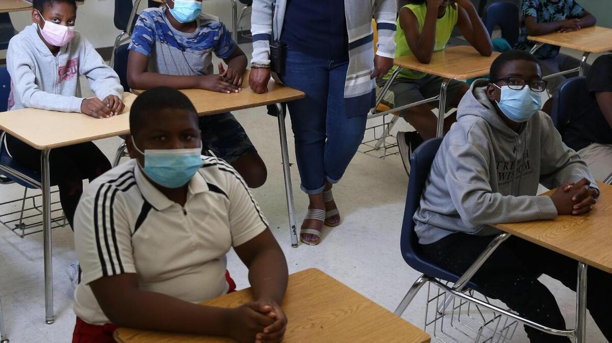North Miami Middle School principal Miriam Stewart visits the FIU All Stars summer school classroom on July 29, 2021. Stewart says she have over 800 students registered to return for the school year and that they are ready with hand sanitizer stations and other safety protocols. Stewart says that kids are consistent following the guidelines as long as the school is consistent, and she has had no issues with students not following the rules when it comes to masks. “My staff and my students want what’s best for all of us and part of that is doing the right thing and keeping each other safe.” Students pictured are front row L-R, Woody Anasthase, and Benedict Richeme. Back row L-R Bianca Mathurin, Elijah Mompremier, Shawn Jenkins and Andy Alexandre.
