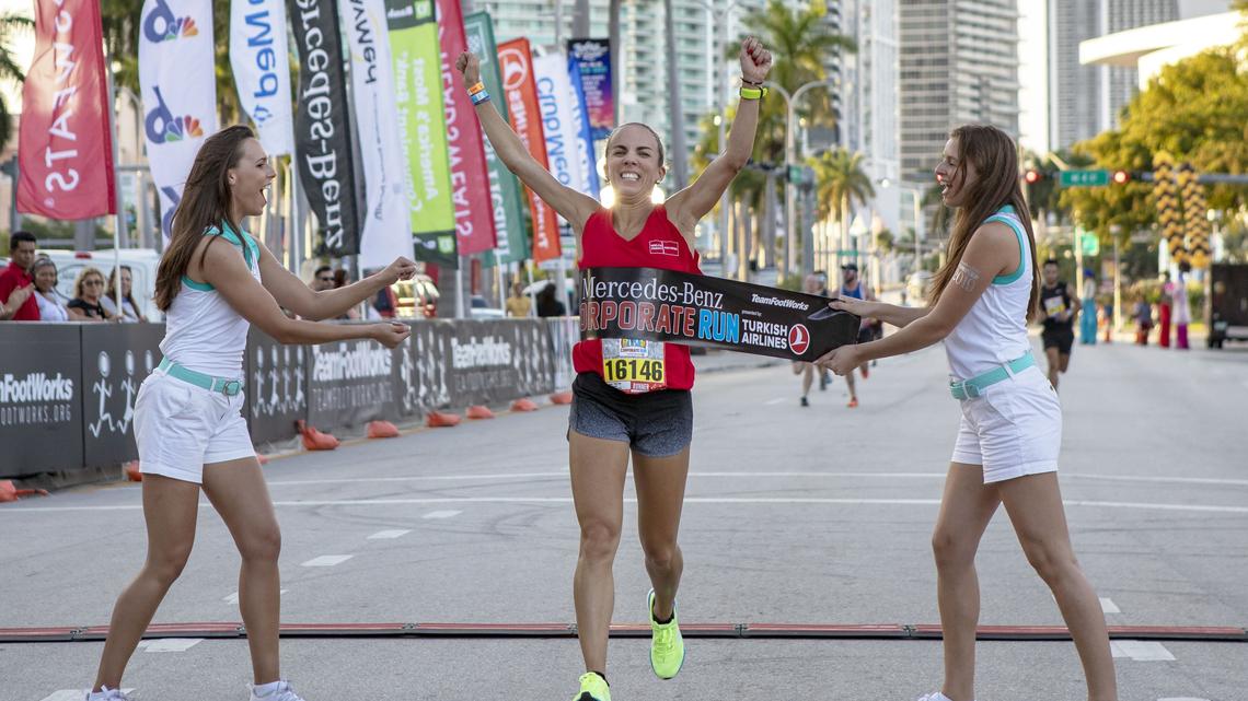 Ana Villegas, 38, from Wells Fargo is the first female to finish the Mercedes-Benz Miami Corporate Run at Bayfront Park in Miami, Florida, on Thursday, April 25, 2019.