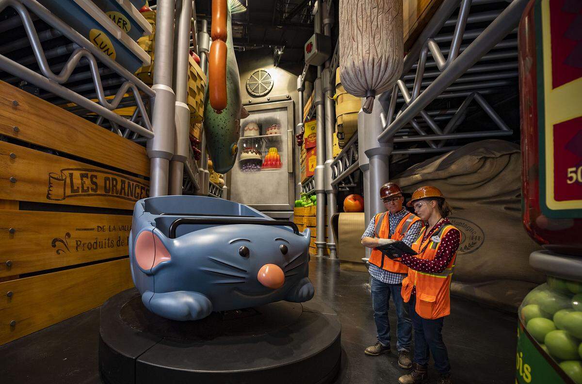 Disney Imagineers work to create Remy’s Ratatouille Adventure, which will magically shrink guests to the size of rats and take them through the kitchen of Gusteau’s Restaurant, past giant hanging sausages and salamis and crates of apples and oranges.