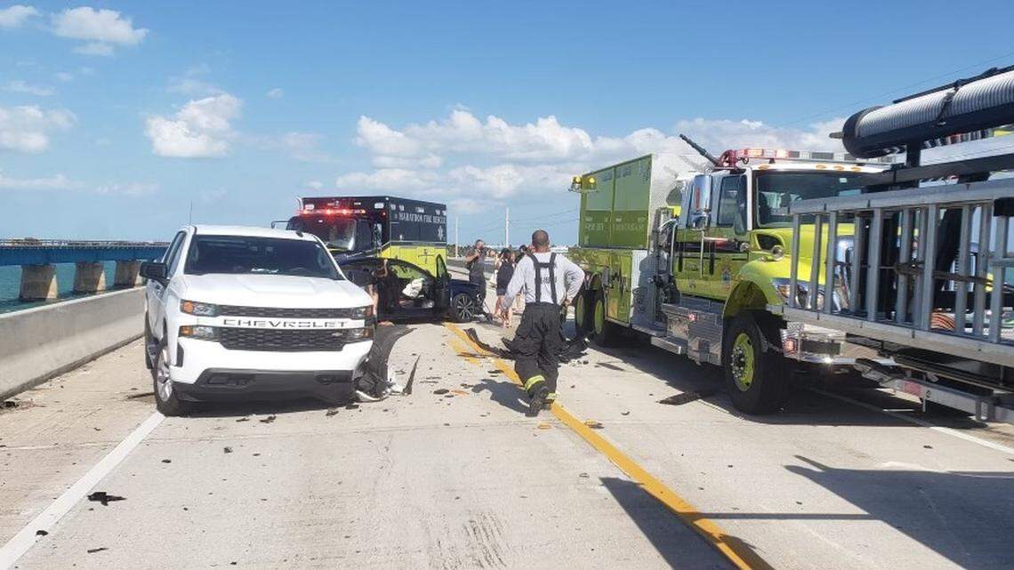 Firefighters, medics and police officers tend to a crash on the Seven Mile Bridge in the Florida Keys Friday, April 2, 2021.