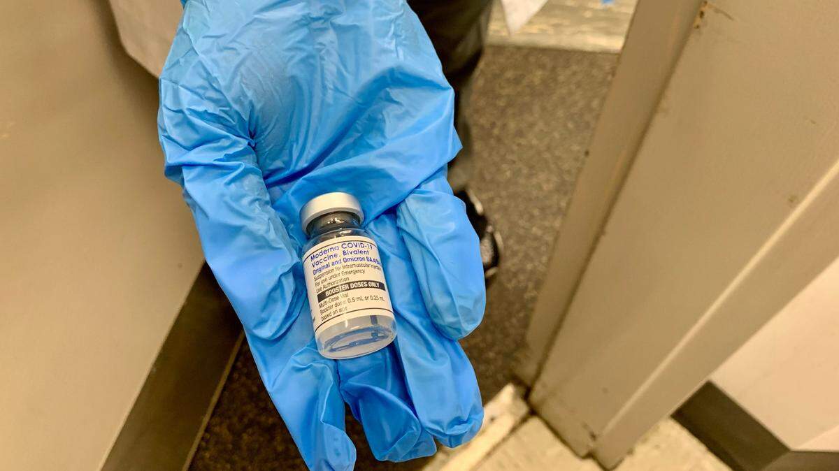 A nurse at a Walgreens pharmacy holds an “updated booster” designed to target not only the original COVID strain, but also omicron BA.4 and BA.5, which had surged in the U.S. through 2022. About 53% of eligible South Carolina residents are fully vaccinated as of Oct. 8, state health data shows.
