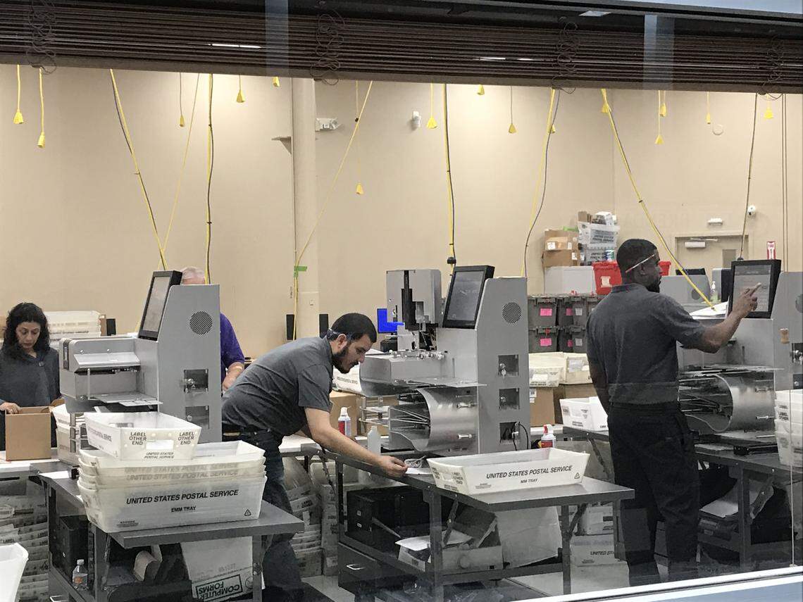 Broward Supervisor of Elections employees count ballots.