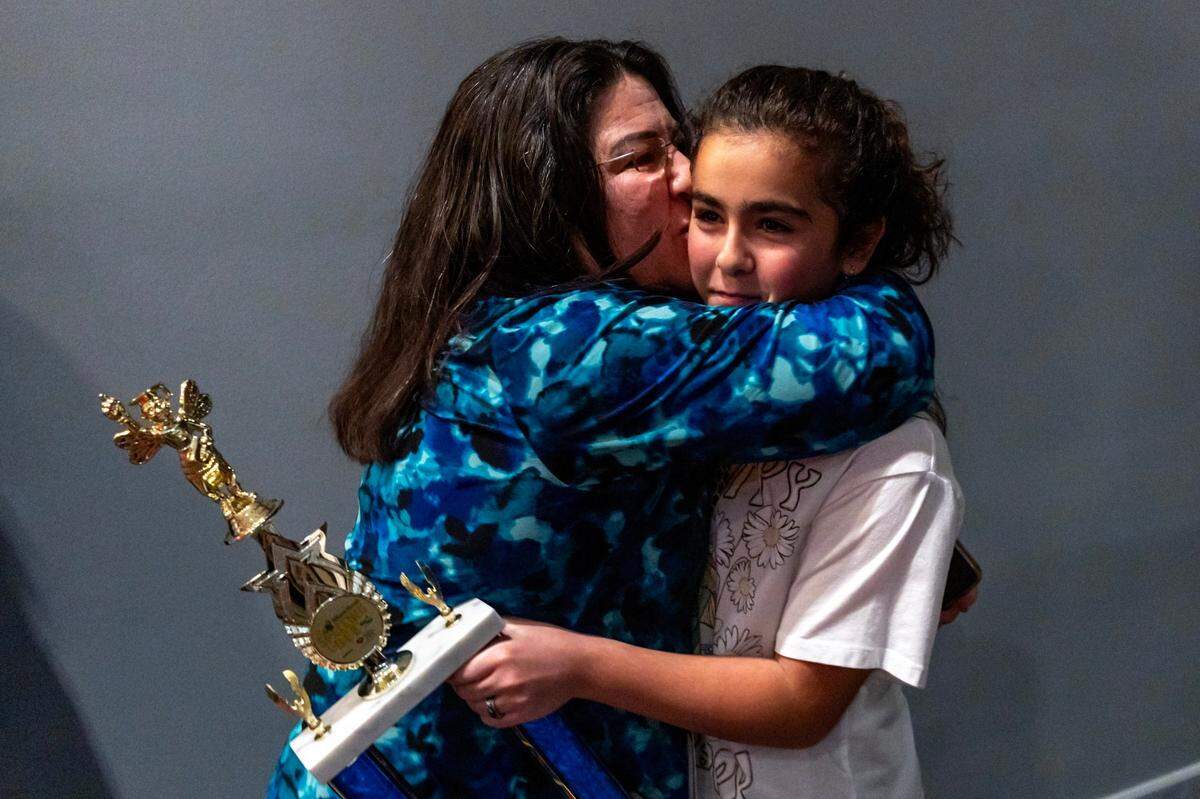 Neisy Mirabal hugs her daughter Jasmine Perez after she won first place during the Miami Herald Broward County Spelling Bee by spelling “Huckleberry” and “Merriment” at NSU Art Museum in Fort Lauderdale, Florida on Thursday, March 7, 2024.