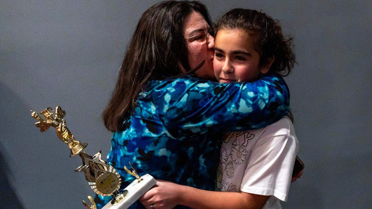 Neisy Mirabal hugs her daughter Jasmine Perez after she won first place during the Miami Herald Broward County Spelling Bee by spelling “Huckleberry” and “Merriment” at NSU Art Museum in Fort Lauderdale, Florida on Thursday, March 7, 2024.