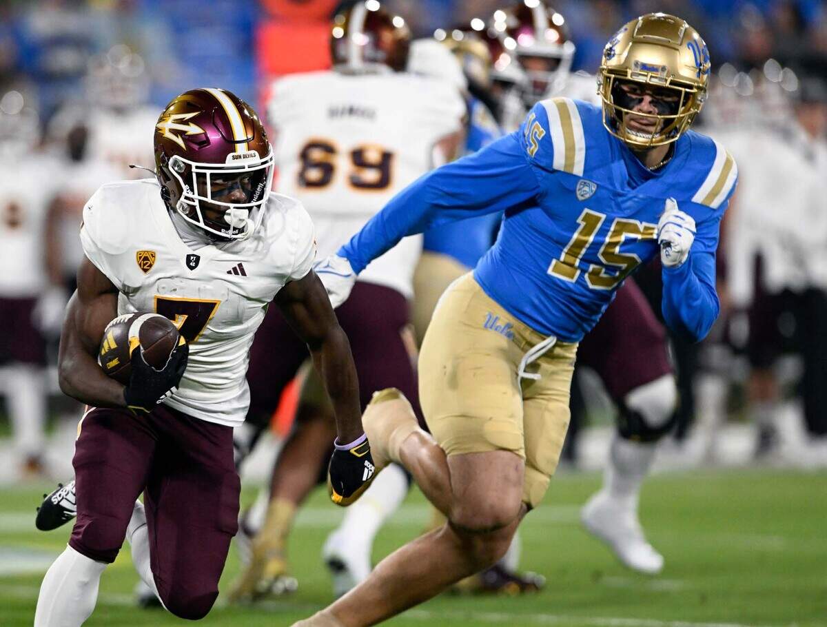 Nov 11, 2023; Pasadena, California, USA; Arizona State Sun Devils wide receiver Melquan Stovall (7) runs against UCLA Bruins defensive lineman Laiatu Latu (15) at the Rose Bowl. Mandatory Credit: Alex Gallardo-USA TODAY Sports