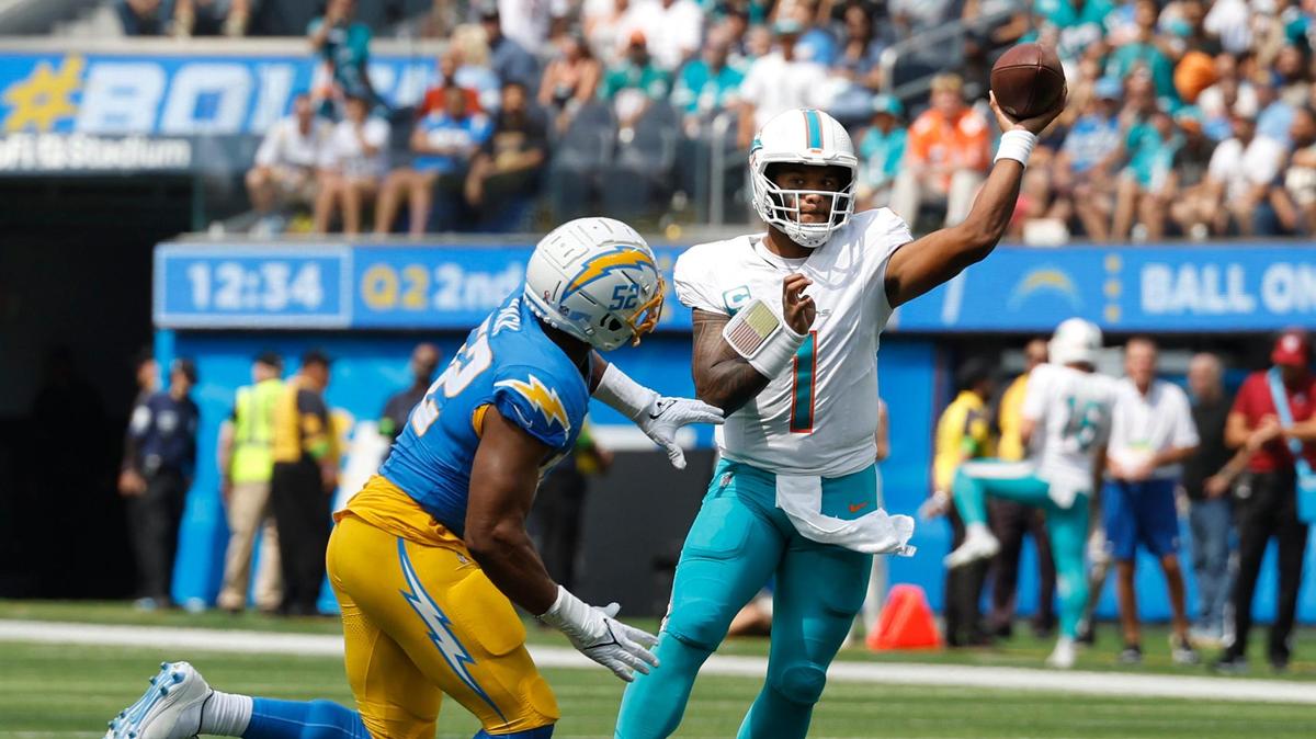 Miami Dolphins quarterback Tua Tagovailoa (1) throws a pass as Los Angeles Chargers safety JT Woods (22) defends during first half of an NFL football game against Los Angeles Chargers at SoFi Stadium in Inglewood, California on Sunday, September 10, 2023.