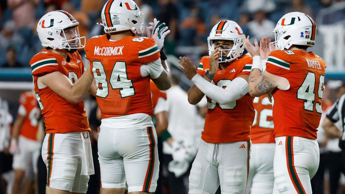 Miami Hurricanes place kicker Andres Borregales (30) reacts with teammates after kicking an extra point against the Virginia Tech Hokies during the first half of an ACC conference football game at Hard Rock Stadium on Friday, September 27, 2024, in Miami Gardens, Fla.