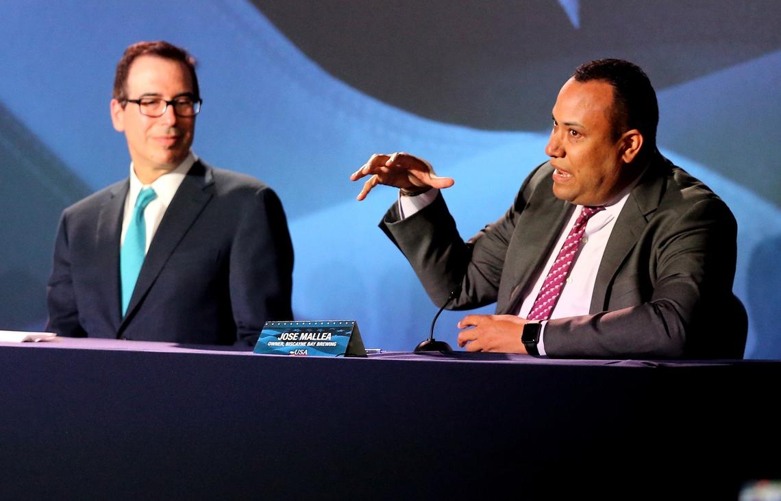Jose Mallea of Biscayne Bay Brewing speaks to President Donald Trump at a roundtable discussion on tax reform as Treasury Secretary Steven Mnuchin listens at Bucky Dent Park in Hialeah on Monday.