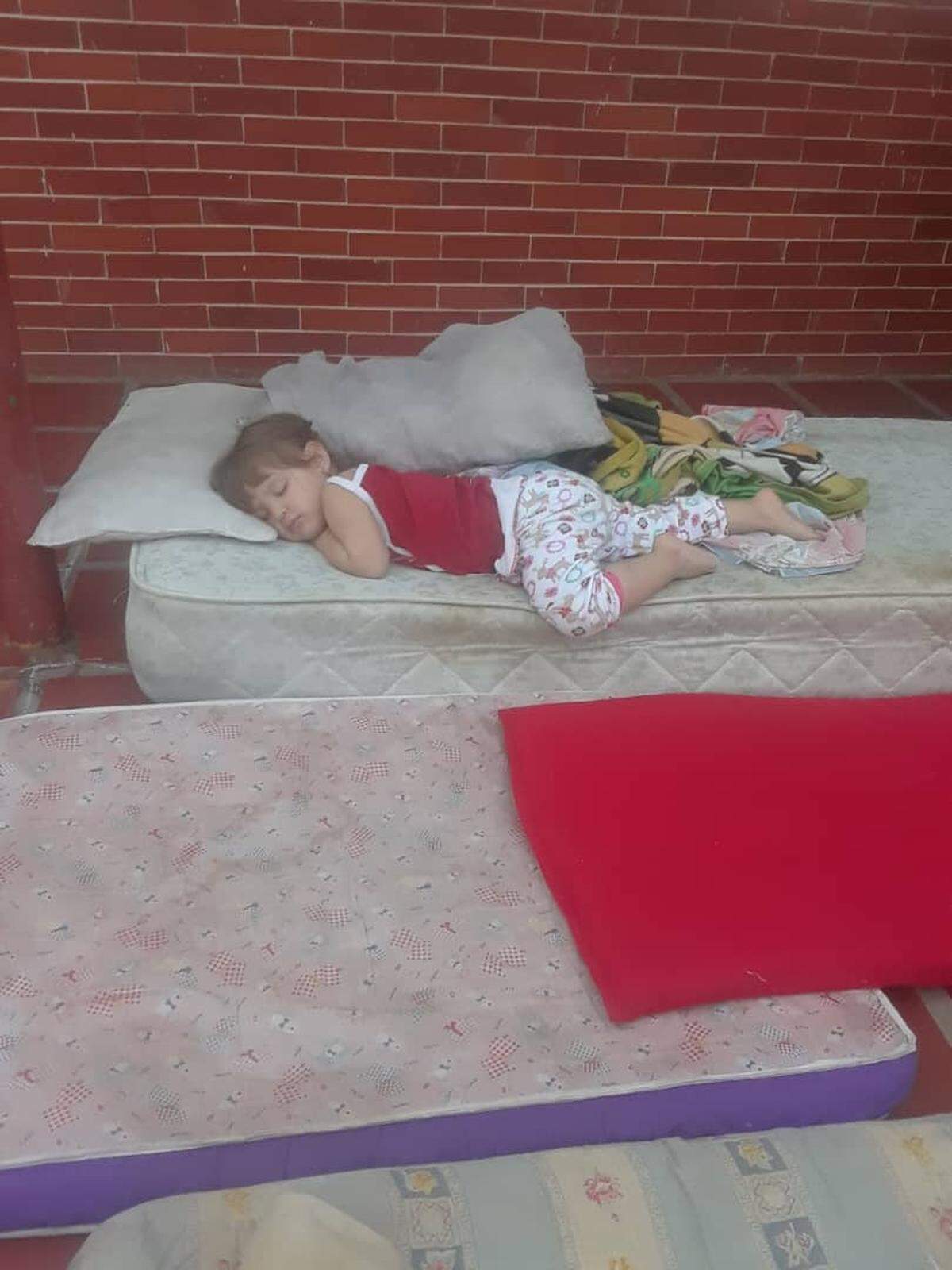 Five-year-old Alessandra sleeps on a mattress outside her home in the state of Zulia to escape the heat inside due to continuing blackouts.