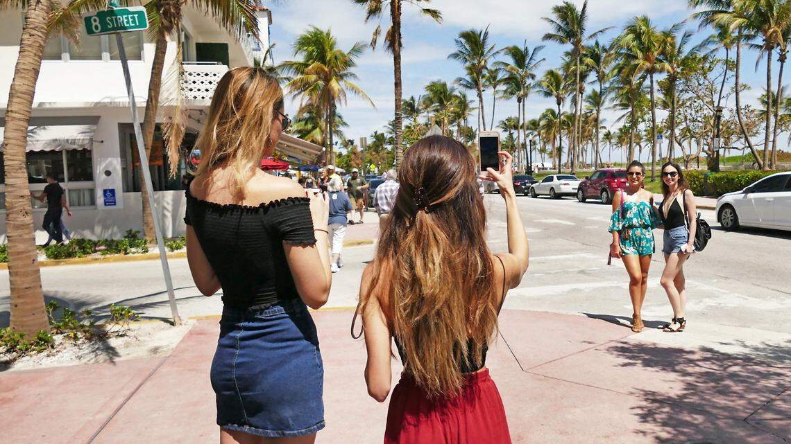 Tourists take pictures on Ocean Drive in Miami Beach on September 24, 2017 following Hurricane Irma.