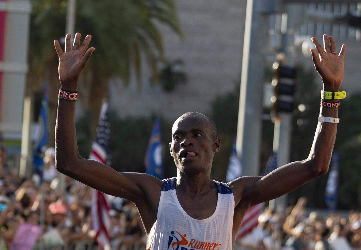 George Onyancha, 28, crosses the line as the first person to finish the full marathon during the Life Time Miami Marathon and Half on Sunday, Jan. 28, 2024, finishing at Bayfront Park in downtown Miami.