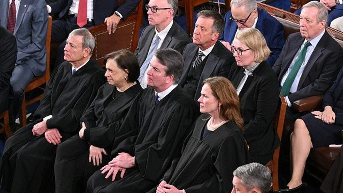 (Front row, L/R) Supreme Court Chief Justice John Roberts, Supreme Court Justice Elena Kagan, Supreme Court Justice Brett Kavanaugh, and Supreme Court Justice Amy Coney Barrett listen as US President Donald Trump delivers the State of the Union address in the House Chamber of the US Capitol in Washington, DC, on February 24, 2026. (Photo by Mandel NGAN / AFP via Getty Images)