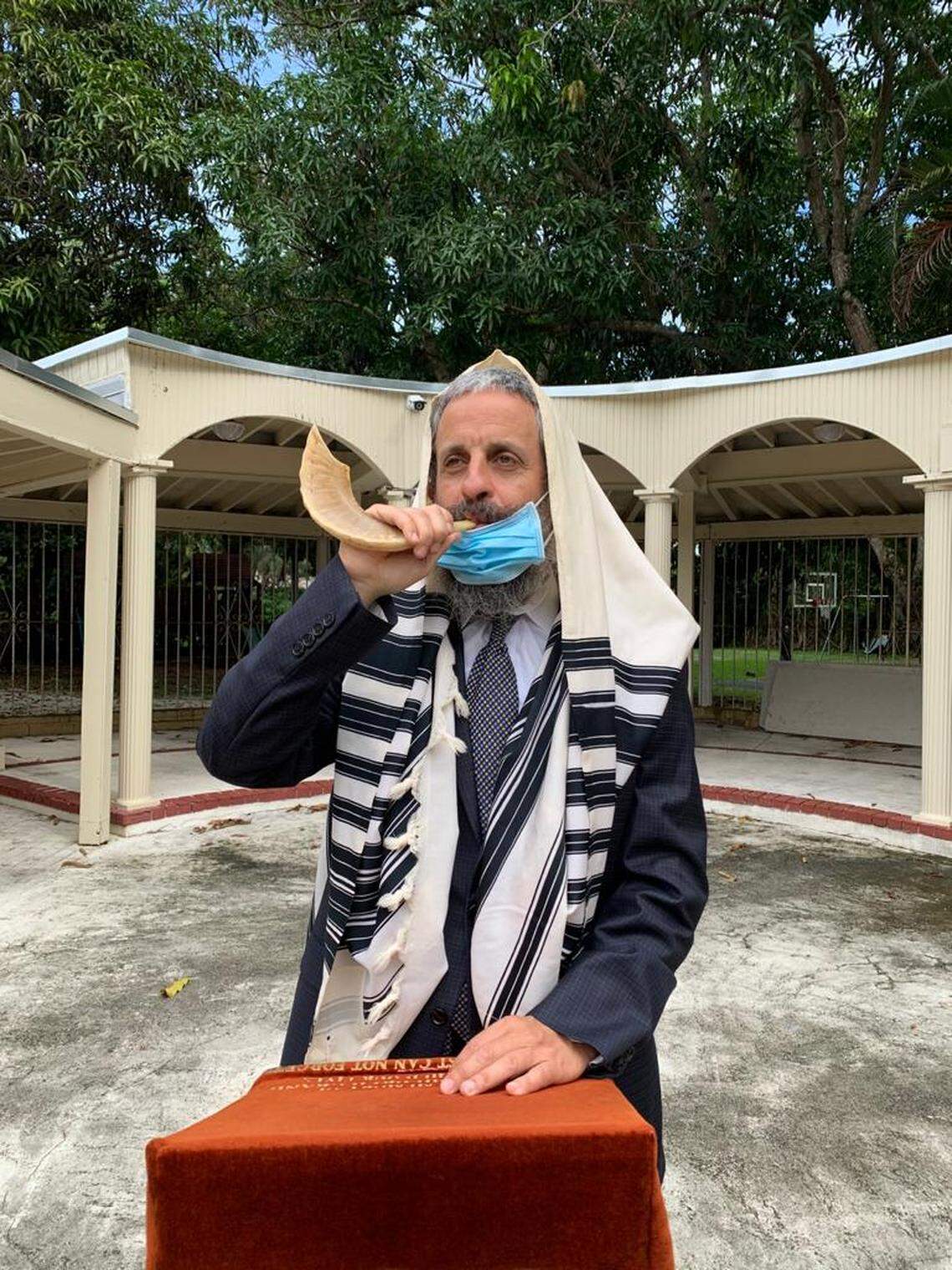 Rabbi Yossi Harlig demonstrates how he will blow the traditional shofar outside the Chabad of Kendall. The chabad will host High Holy Days services indoors and outdoors and livestream during the pandemic in September 2020.