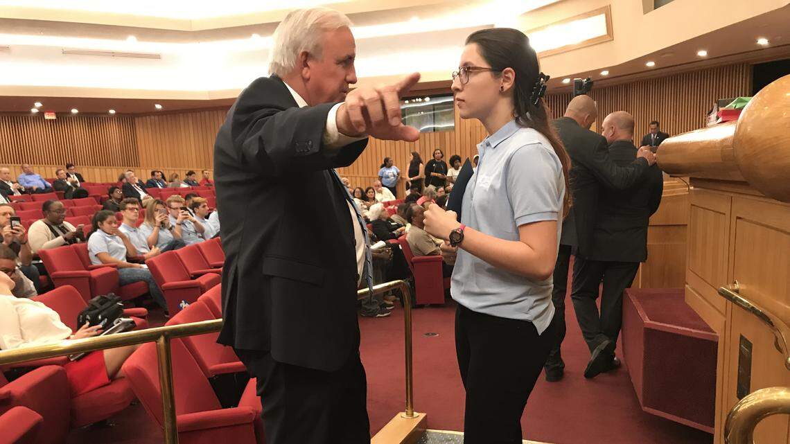 Miami-Dade Mayor Carlos Gimenez makes a point with Miami Dade College student Rebecca Diaz, who came to Thursday night’s budget hearing and urged the County Commission to overrule the mayor and approve an early-voting site for the community college. The board voted to put a site on MDC’s north campus. After the vote, Gimenez said he would add a second MDC site for the school’s Kendall campus as well.