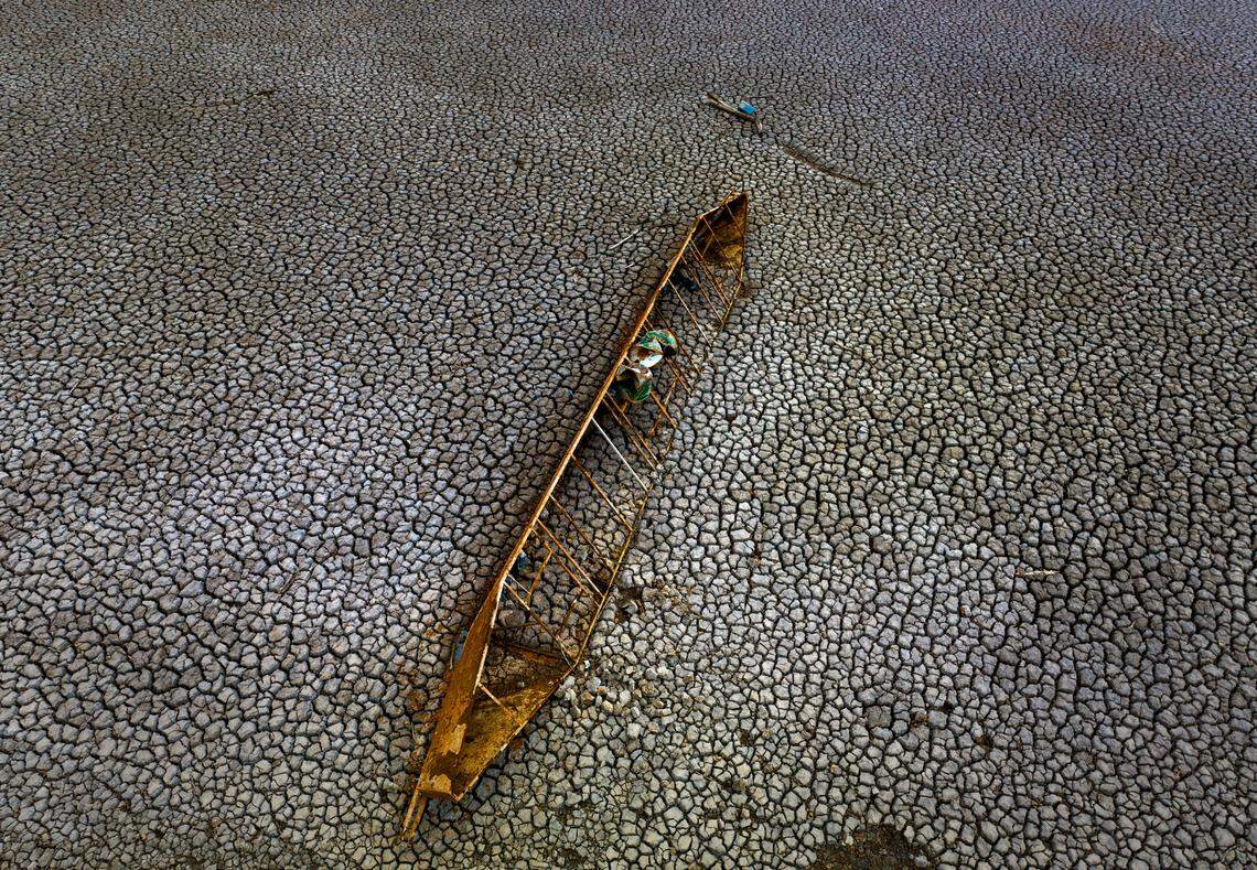 An old boat seen half-buried on the dry floor of the Sau reservoir.