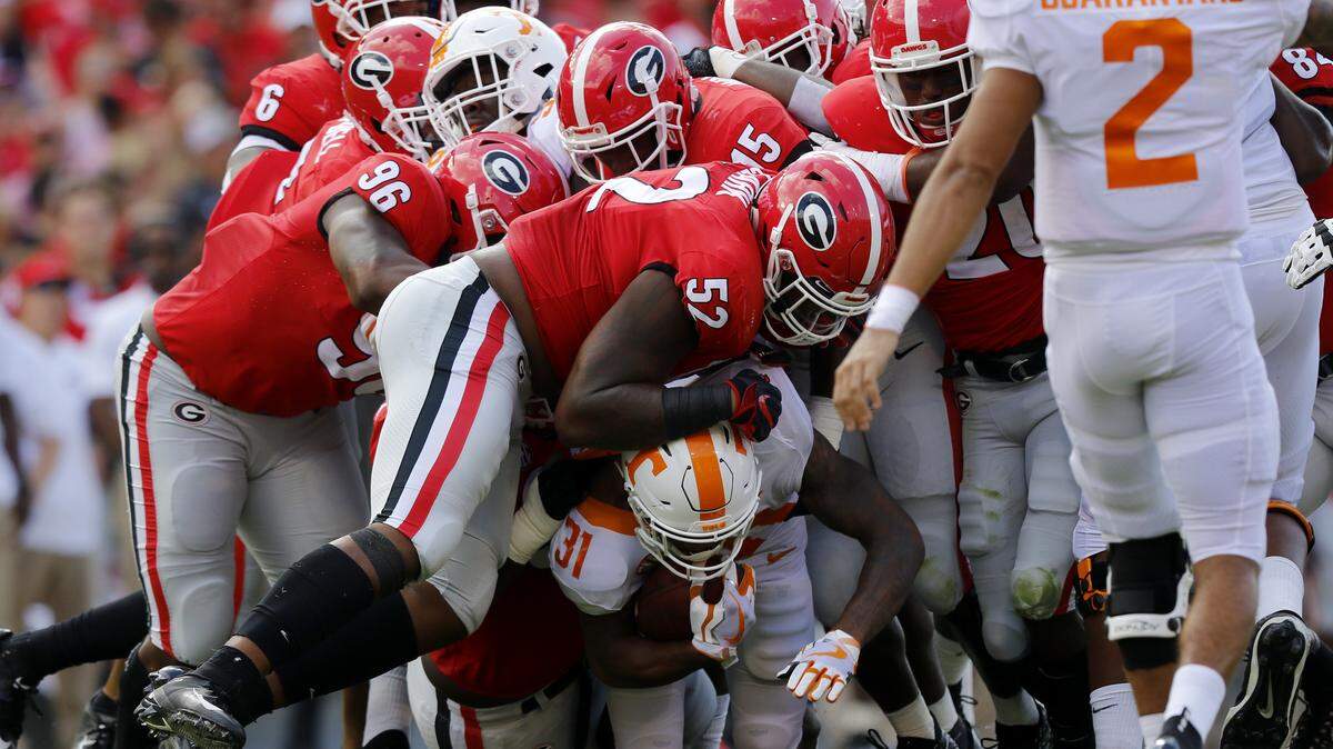 Tennessee’s running back Madre London (31) is bottled up by the Georgia defense during an NCAA college football game in Athens, Ga., Saturday, Sept. 29, 2018.