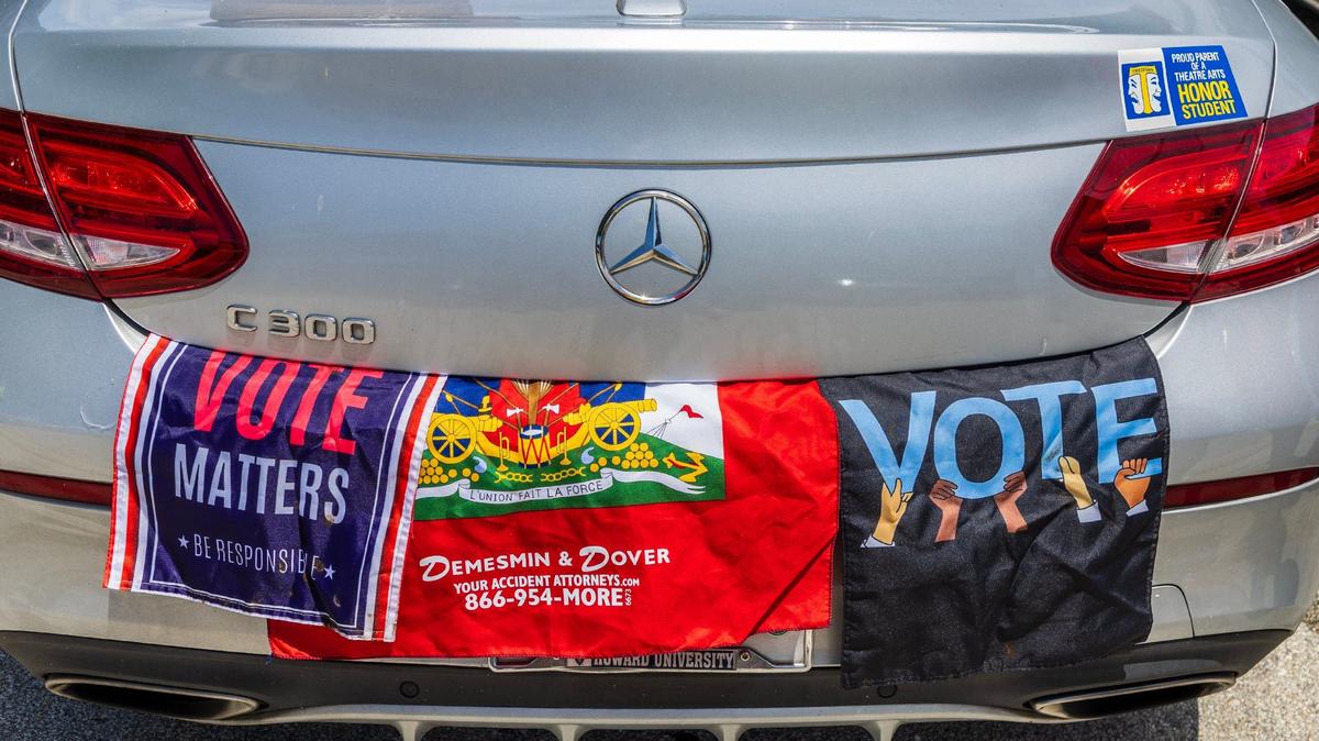 A Haitian flag and voters flyers seen in a car participating in a caravan led by Haitian organizers to show support for the Harris campaign that began at the Little Haiti Cultural Center in Miami and traveled to the North Miami Library, on Saturday, August 10, 2024.